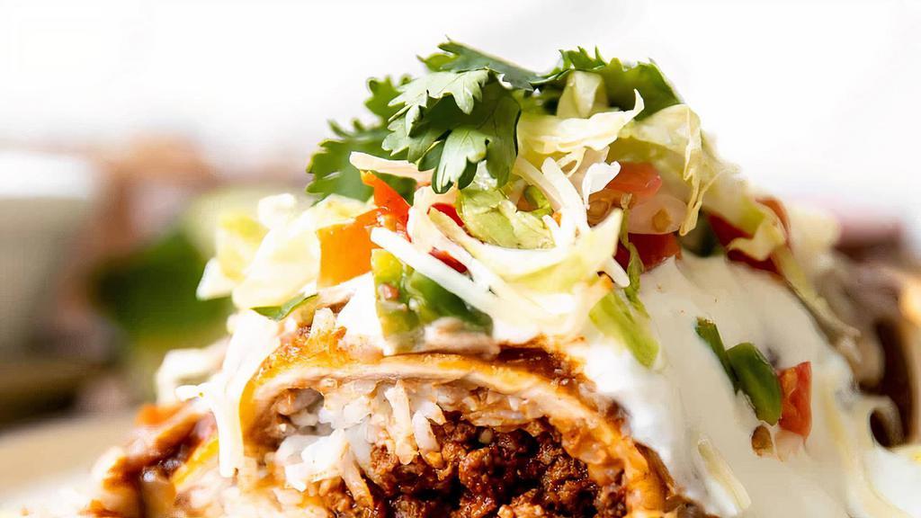 Super Wet Burrito · Choice of meat, topped with green or red sauce, beans, rice, guacamole, sour cream, onion, cilantro, salsa, salad on the side.