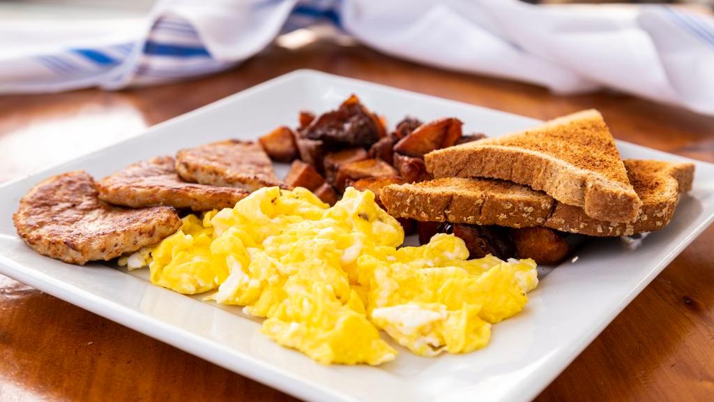 American Breakfast · Scrambled eggs, homemade potatoes and whole wheat bread.