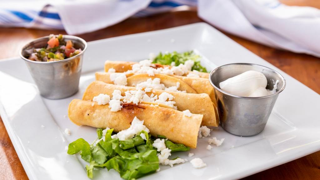 Flautitas · Four mini crispy corn tortillas filled with chicken, fresh pico de gallo, shredded lettuce, queso fresco and sour cream.