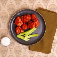 Boneless Buffalo Wings · Six crispy breaded boneless wings tossed in a spicy buffalo sauce and served with ranch or b...