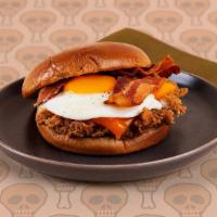 Breakfast Fried Chicken Sandwich · Crispy fried chicken breast with crispy bacon, melted cheddar cheese, and a fried egg on a b...