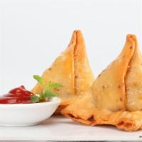 Samosas · Vegan. Crispy turnovers filled with veggies with a side of mint chutney; two pcs.