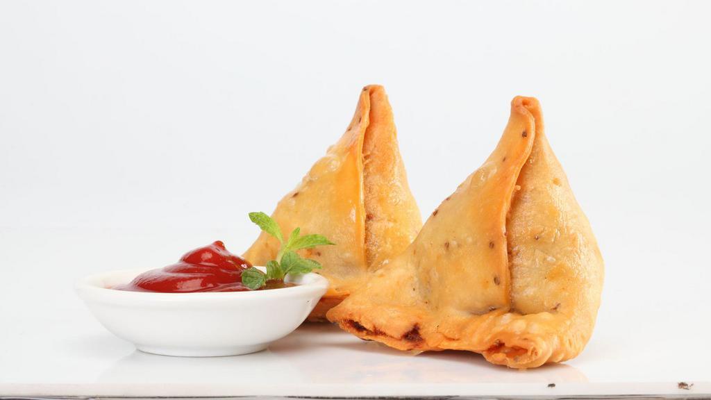 Samosas · Crispy turnovers filled with veggies with a side of mint chutney; 2 pcs; Vegan.