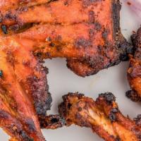 Tandoori Chicken (Half) · Gluten-free. One leg and one breast piece marinated in traditional spices then baked in a ta...