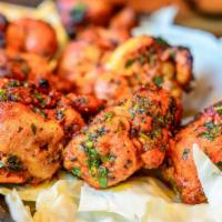 Chicken Tikka Kebab · Tender chicken skewers marinated in traditional spices then baked in a tandoor clay oven; Gl...
