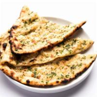 Garlic Naan · Traditional bread baked in a tandoor oven and topped with fresh garlic.