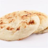 Naan · Traditional bread baked in a tandoor oven.