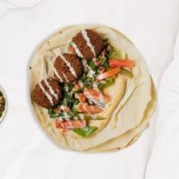 Free-Falling Falafel Wrap · Ground chickpeas, onions, garlic, and parsley blended with Mediterranean spices, then formed...