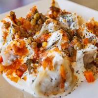 Mantu · Seasoned ground beef filled dumplings topped with lentils and yogurt sauce.