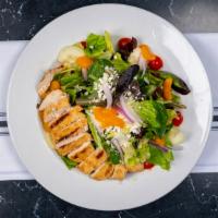 Grilled Chicken Salad · Spring greens and romaine lettuce, tomatoes, red onions, mandarin oranges, feta, and Parmesa...