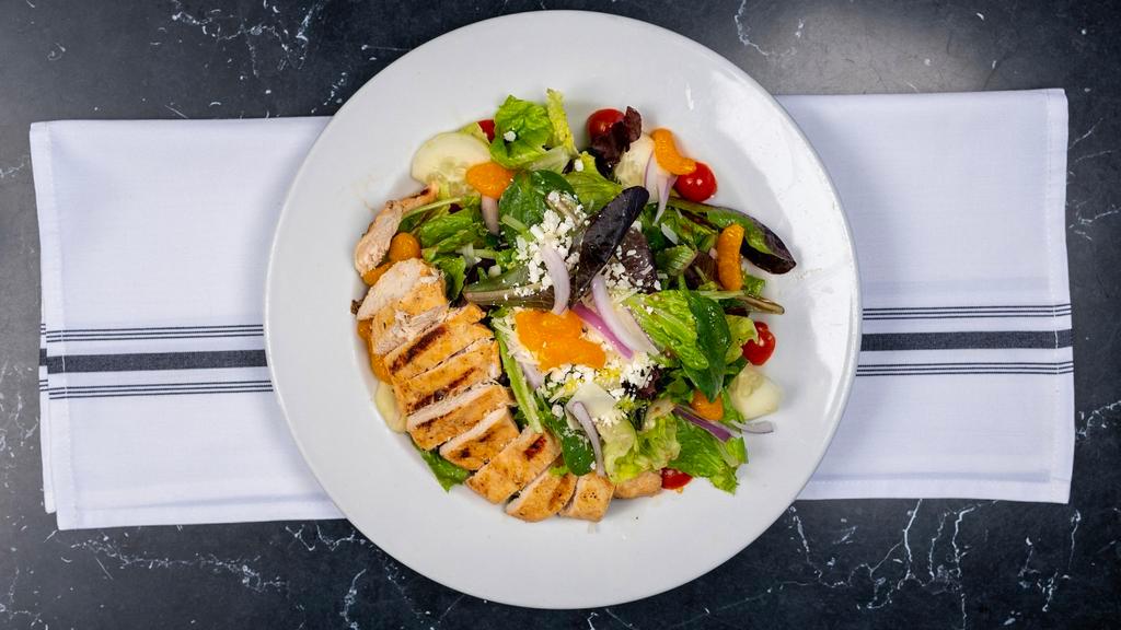 Grilled Chicken Salad · Spring greens and romaine lettuce, tomatoes, red onions, mandarin oranges, feta, and Parmesan cheese – topped with grilled chicken breast, - tossed in a balsamic vinaigrette.