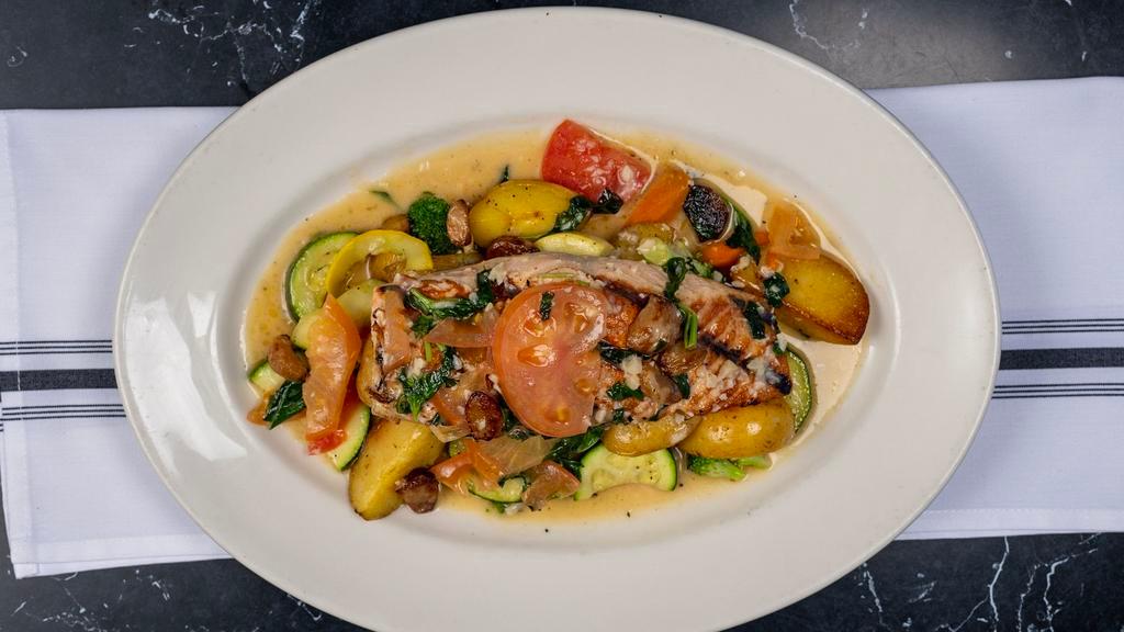 Grilled Salmon · Topped with roasted garlic, fresh tomatoes, and basil – tossed in a lemon-butter white wine sauce and served with vegetables and roasted potatoes.