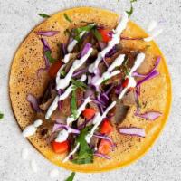 Beef and Lamb Gyro Taco · Flavorful beef and lamb gyro with shredded cabbage, diced tomatoes, cilantro, and tzatziki o...