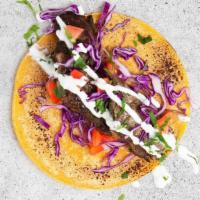 Kofte Kabob Taco · Savory beef kofte with shredded cabbage, diced tomatoes, cilantro, and tzatziki or tahini in...