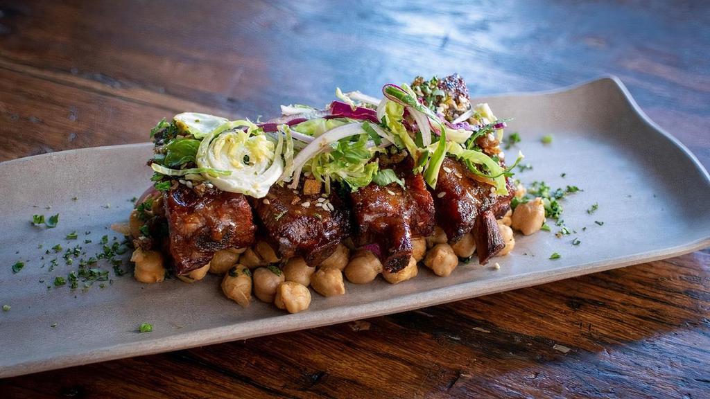 Roasted Island Pork Ribs · Warm Cannellini bean salad, pickled Brussels sprout, plantain bacon 