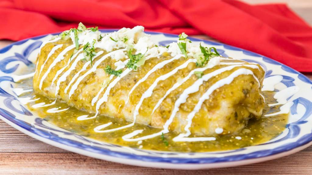 Burrito Mojado · Asada or chicken, Mexican rice, pinto beans, mozzarella cheese, lettuce,covered in red or green salsa.
