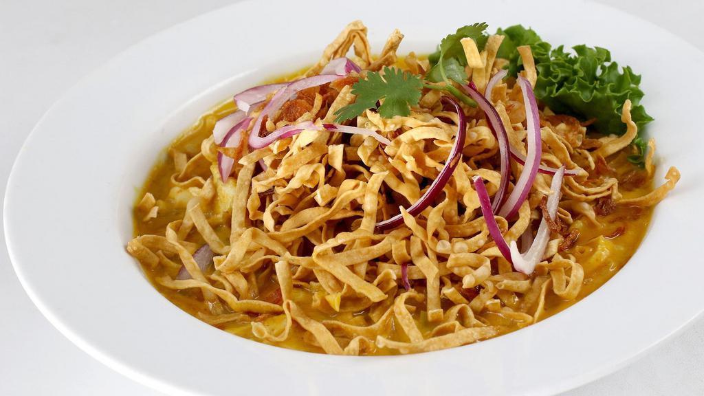 Kao Soy · Egg noodles topped with yellow curry, chicken or tofu, pickled mustard greens, red and crispy onions.