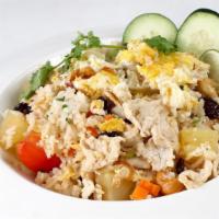 Pineapple Fried Rice · Eggs, cashew nuts, raisins, onions, carrots, and your choice of beef, pork, or chicken.