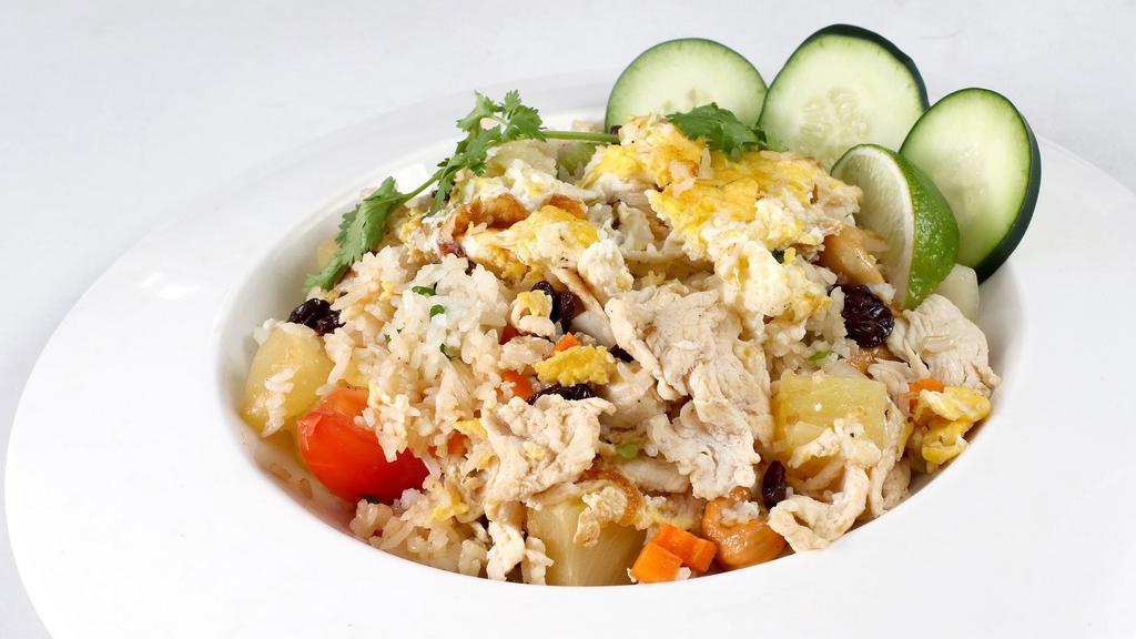 Pineapple Fried Rice · Eggs, cashew nuts, raisins, onions, carrots, and your choice of beef, pork, or chicken.