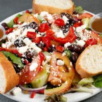 Classic Greek Salad · Mixed greens, roasted eggplant, red bell peppers, feta, english cucumbers and tomatoes in a ...