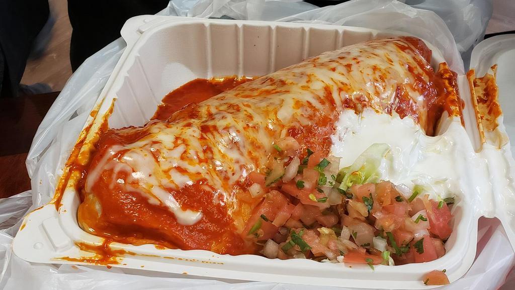 Wet Burrito · Rice and beans, pico de gallo, guacamole, cheese sour cream, choice of meat and red sauce on top.