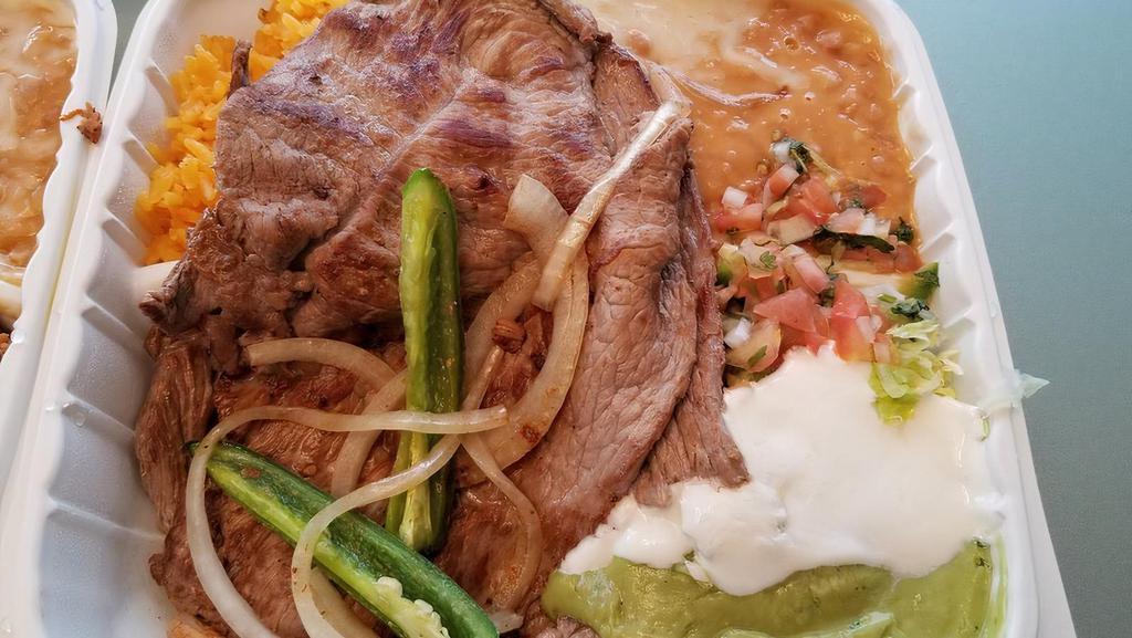 Plato Carne Asada · 2 pieces of steak  rice, beans,guacamole,sour cream, pico de Gallo and lettuce.