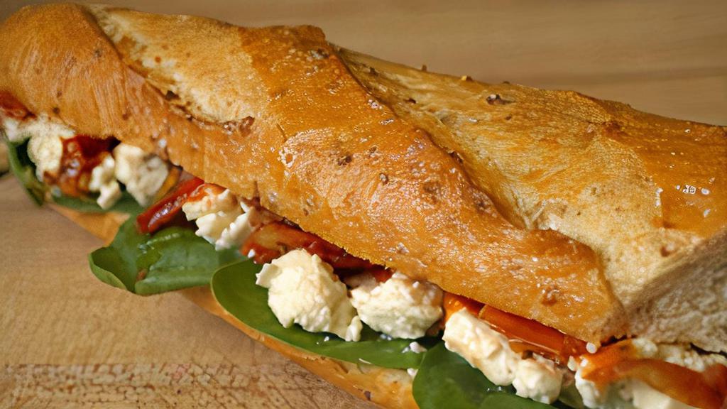 Greek · Fresh spinach, roasted tomatoes, kalamata olive tapenade and feta cheese on a 9-grain baguette.