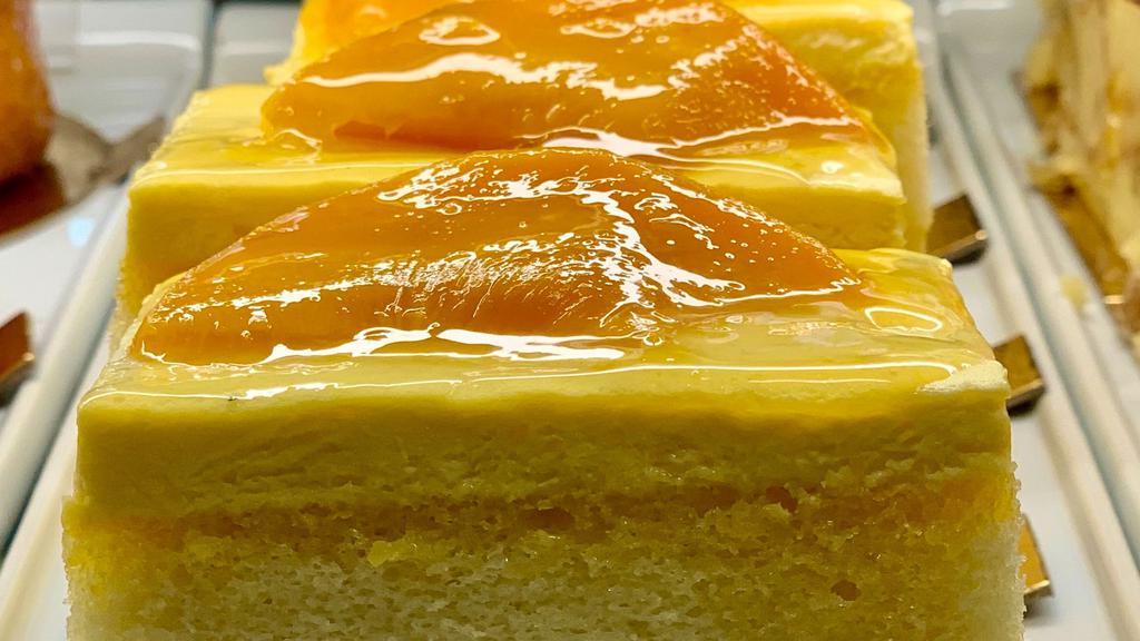Mango Mousse · Two layers of mango infused champagne white chiffon cake, two layers of mango mousse, topped with fresh mango slices and apricot glaze.