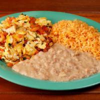 Huevos a la Mexicana · Scrambled eggs with salsa fresca. Served with rice and beans. Try it on a plate or burrito s...