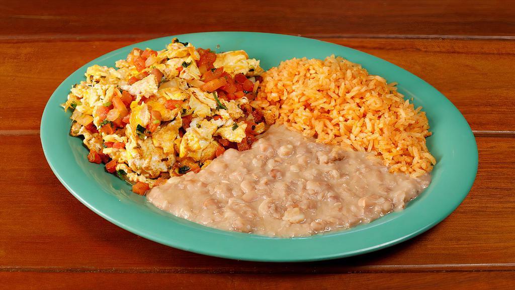 Huevos a la Mexicana · Scrambled eggs with salsa fresca. Served with rice and beans. Try it on a plate or burrito style.
