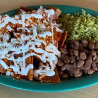 Chilaquiles Rojo · Sliced corn crispy tortillas, mixed with egg and cooked in a traditional red sauce topped wi...