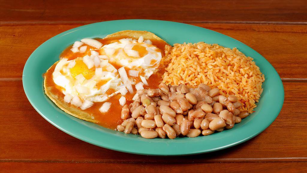 Huevos Rancheros · The original - eggs served sunny side up with fried corn tortillas and a delicious sauce topped with onions. Served with rice and beans.