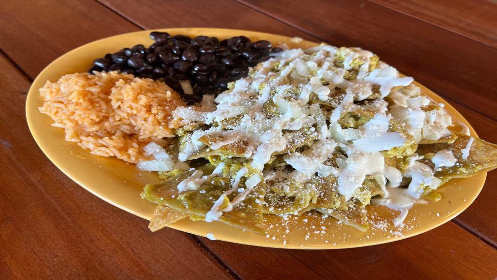Chilaquiles Verde · Sliced crispy corn tortillas, mixed with egg and cooked in a tasty green sauce topped with onions, sour cream and cotija cheese. Served with rice and beans.