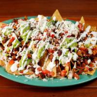 Meat Nachos · Homemade chips topped with Cheese, guacamole, sour cream, salsa fresca and your choice of me...