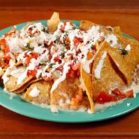 Cheese Nachos · Homemade chips topped with Cheese, guacamole, sour cream, salsa fresca and your choice of be...
