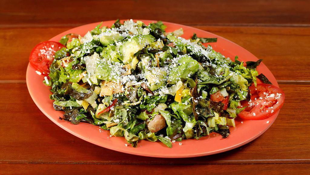 Lulu's Chopped Salad - Large · Mixed lettuce, napa cabbage, bell peppers, corn, avocado, tomato, pepitas, Mexican cheese, tortilla chips with a cilantro dressing. Add chicken, beef, pork, or seafood to your salad.