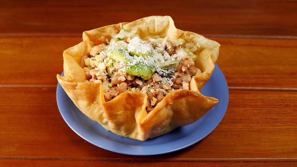 Taco Salad with chicken or pork · Your choice of meat, vegetarian beans, lettuce, corn, avocado, salsa fresco, and cheese served in a flour tortilla shell.
