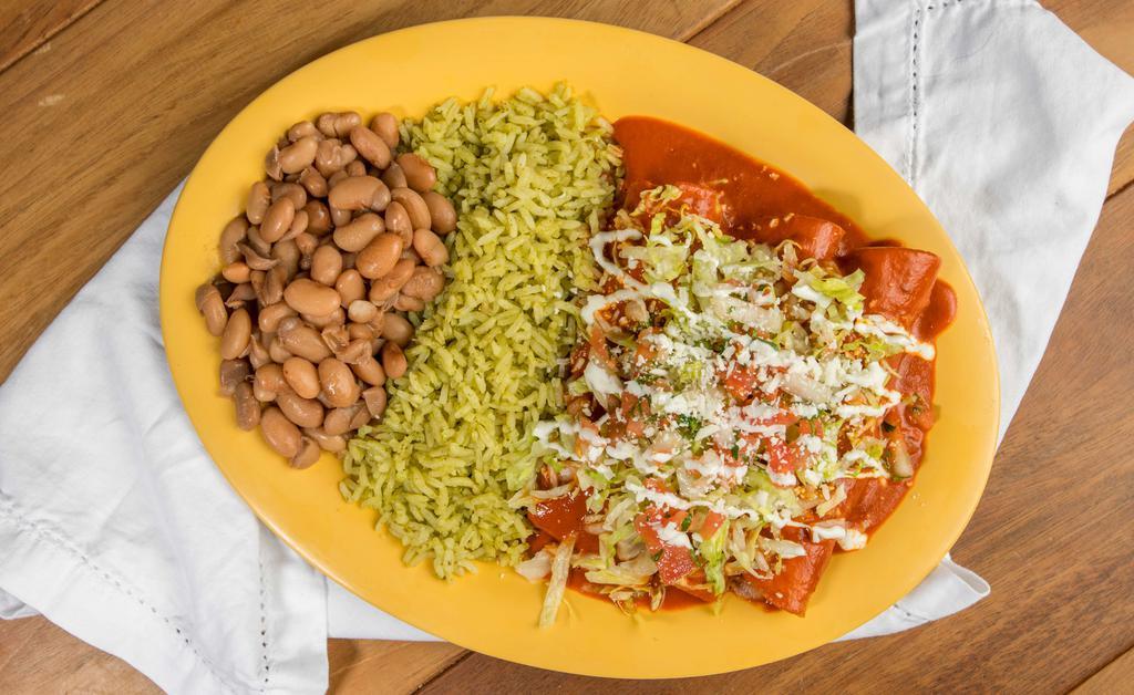 Enchilada Plate - Meat · Plate. Three hand rolled corn tortillas with your choice of meat and sauce, topped with lettuce, cheese, sour cream, and salsa fresca. Served with your choice of rice and vegetarian beans.