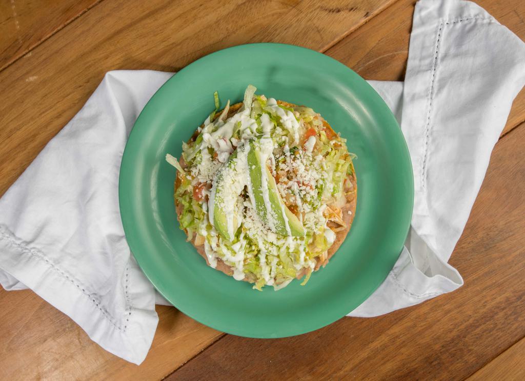 Tostada · Flat, crisp corn tortilla topped with your choice of meat and beans, lettuce, Mexican cheese, avocado, sour cream, and salsa fresca.