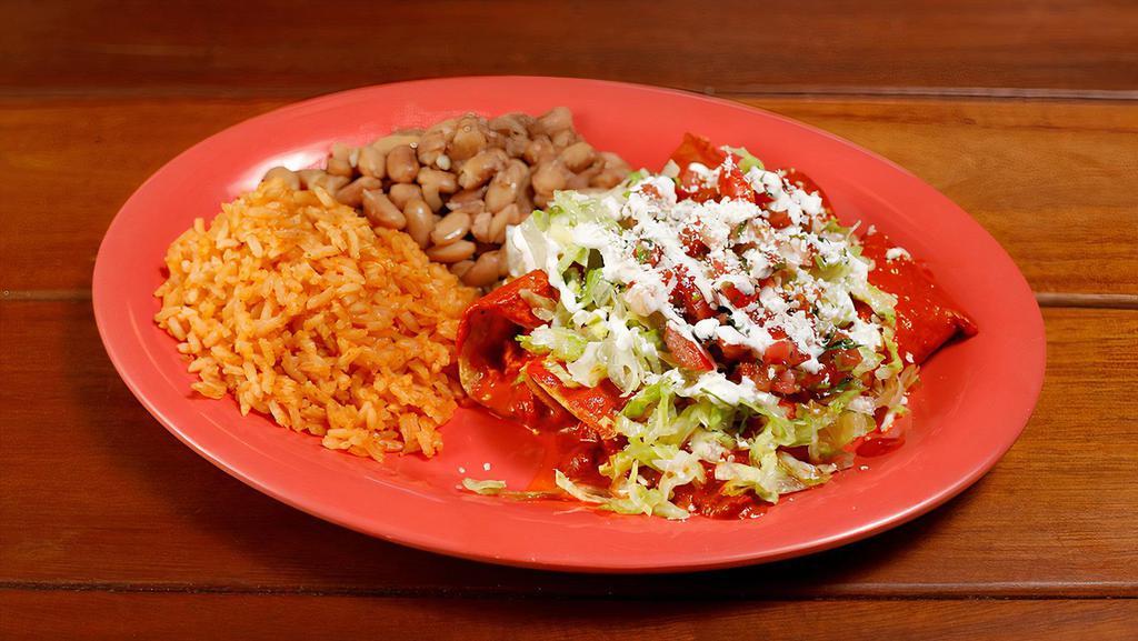 Enchiladas - Meat (2) · Hand rolled corn tortillas in a red or green sauce filled with your choice of meat and topped with lettuce, cheese, sour cream, and salsa fresca.