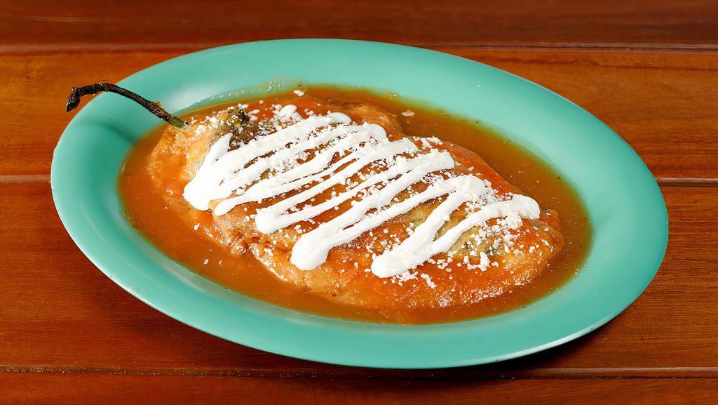 Chile Relleno (1) · Roasted pasilla pepper stuffed with monterey jack cheese topped with salsa caliente, Mexican cheese  and sour cream.