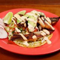 Fish Taco · Grilled fresh fish marinated in garlic, served on a corn tortilla topped with lettuce, salsa...