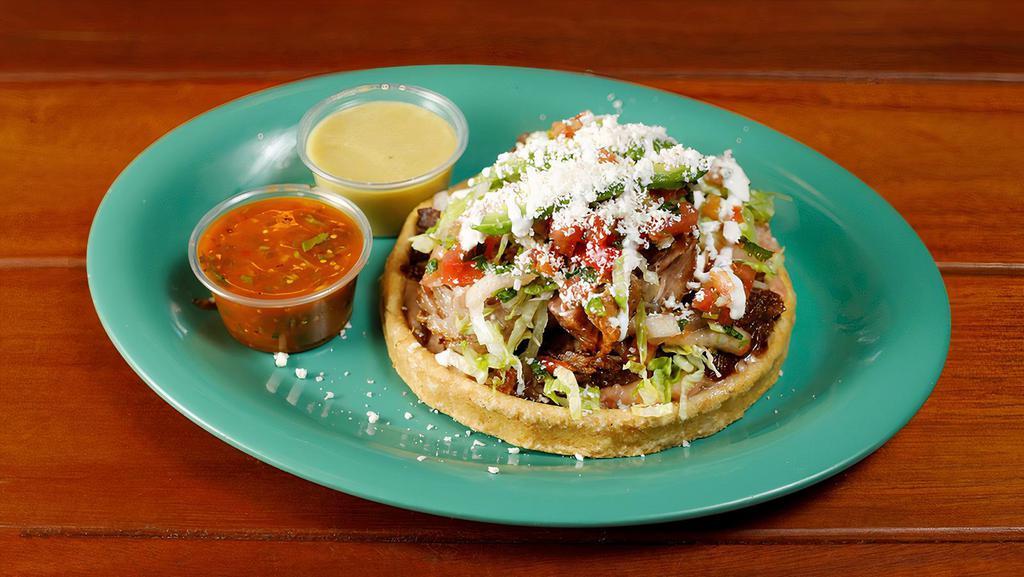Sope  · Masa Shells (ground corn) topped with your choice of meat or grilled vegetables, refried beans, lettuce, sour cream, Mexican queso, sliced tomato and sliced avocado