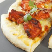 Chicken Tandoori Pizza · Oven-baked pizza with tandoori sauce, topped with tandoori chicken pieces, mushrooms, red on...