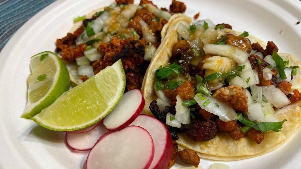 Tacos · Choice of meat, onion, coriander, radishes, lemons, and pico de gallo.