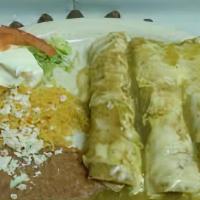 Enchiladas · Choice of meat: chicken or beef, cheese, sauce, beans, rice, cream, fresh cheese, with a sid...
