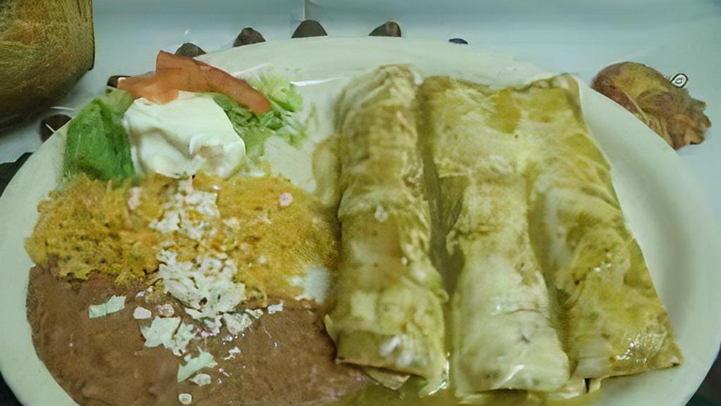 Enchiladas · Choice of meat: chicken or beef, cheese, sauce, beans, rice, cream, fresh cheese, with a side of salad.