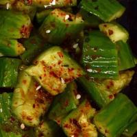 Cucumber Salad 凉拍黄瓜 · Asian cucumbers cut and smashed, tossed in black vinegar, garlic, and chili oil.