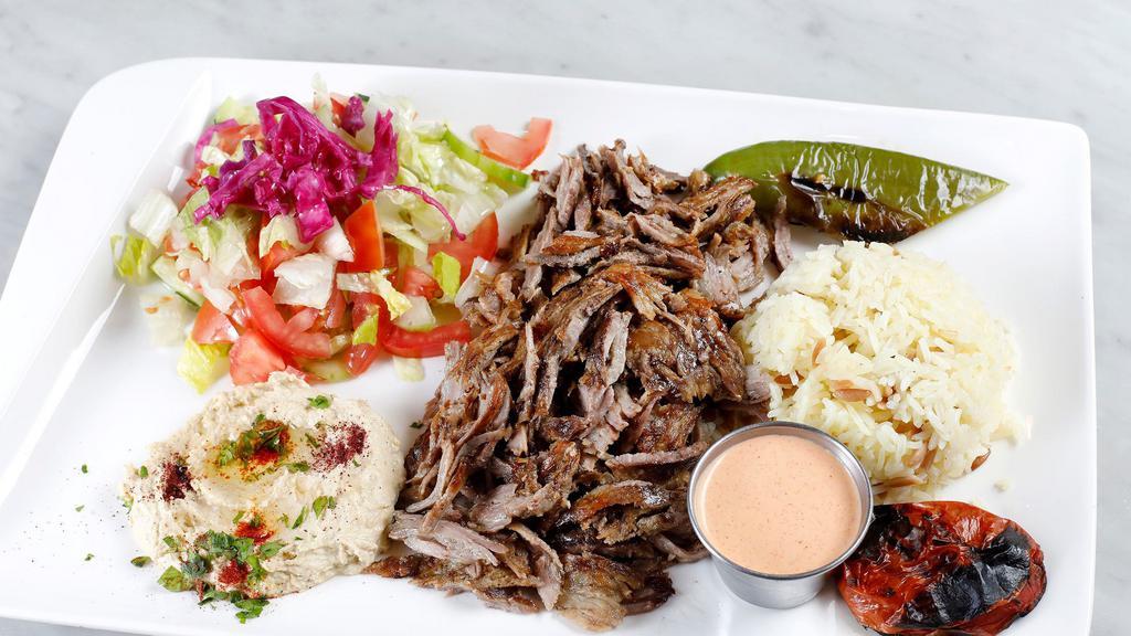 Lamb & Beef Gyros Plate · Daily cut and cooked lamb and beef meat gyro, rice, hummus and salad(tomatoes, cucumber, romaine hearts), roasted slice and green pepper, tzatziki sauce and optional hot sauce(1.5oz) side comes with pita bread