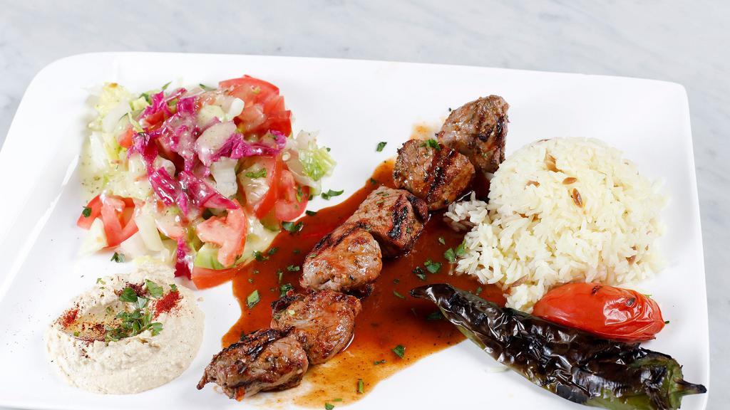 Beef Shish Kebab Plate · Charcoal grilled skewered beef cubes. Served with rice, salad, pita bread, and hummus.